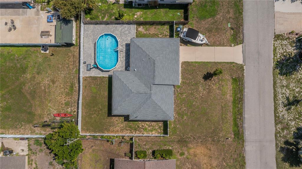 An aerial view shows a house with a gray roof, a pool, and a boat parked — 1510 NANTUCKET ROAD, VENICE, FL