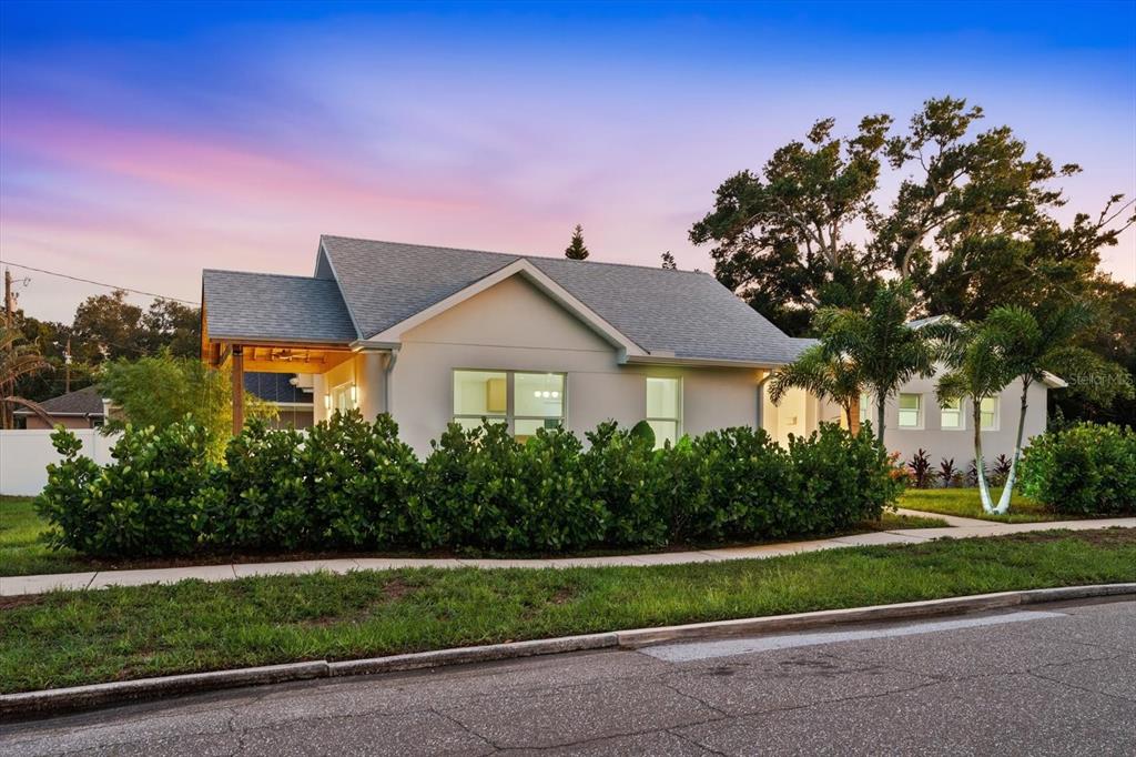 A single-story house with a gray roof, white exterior, and a hedge in the front yard — 4847 DR MARTIN LUTHER KING JR STREET N, ST PETERSBURG, FL