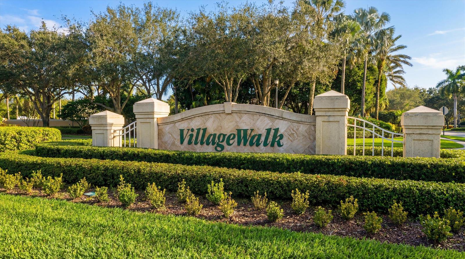 A stone monument sign for VillageWalk sits behind a manicured hedge and green lawn — 8049 Nevis Place, Wellington FL 33414, WELLINGTON, FL