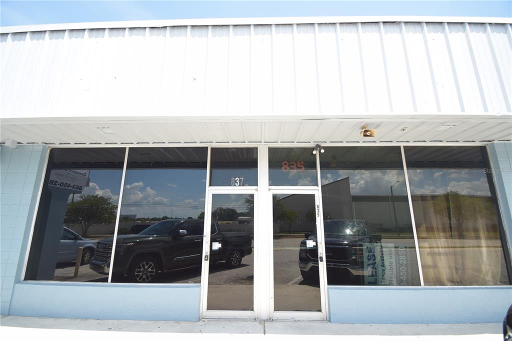 The exterior of a commercial building features two glass entry doors and large display windows — 835/837 N LAKE PARKER AVENUE UNIT 835/837, LAKELAND, FL
