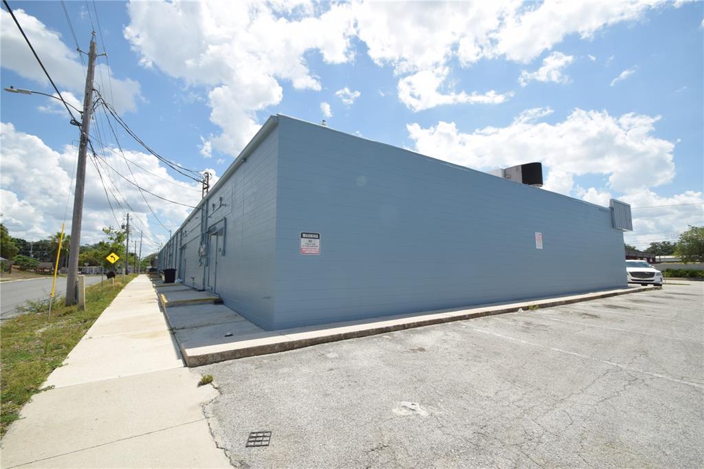 A light blue commercial building exterior with a paved parking lot and adjacent sidewalk — 835/837 N LAKE PARKER AVENUE UNIT 835/837, LAKELAND, FL
