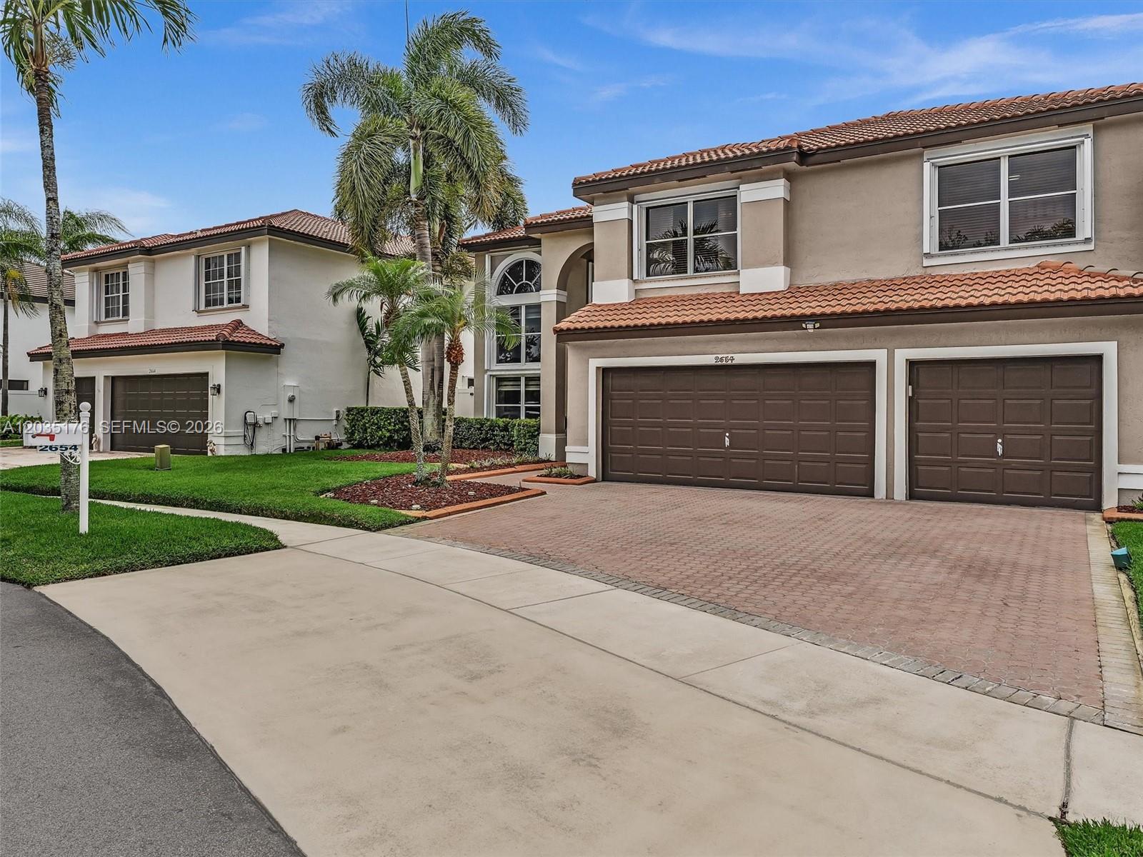 A two-story house with a brown garage and a paved driveway under a blue sky — 2654 SW 181st Ter, Miramar FL 33029, MIRAMAR, FL