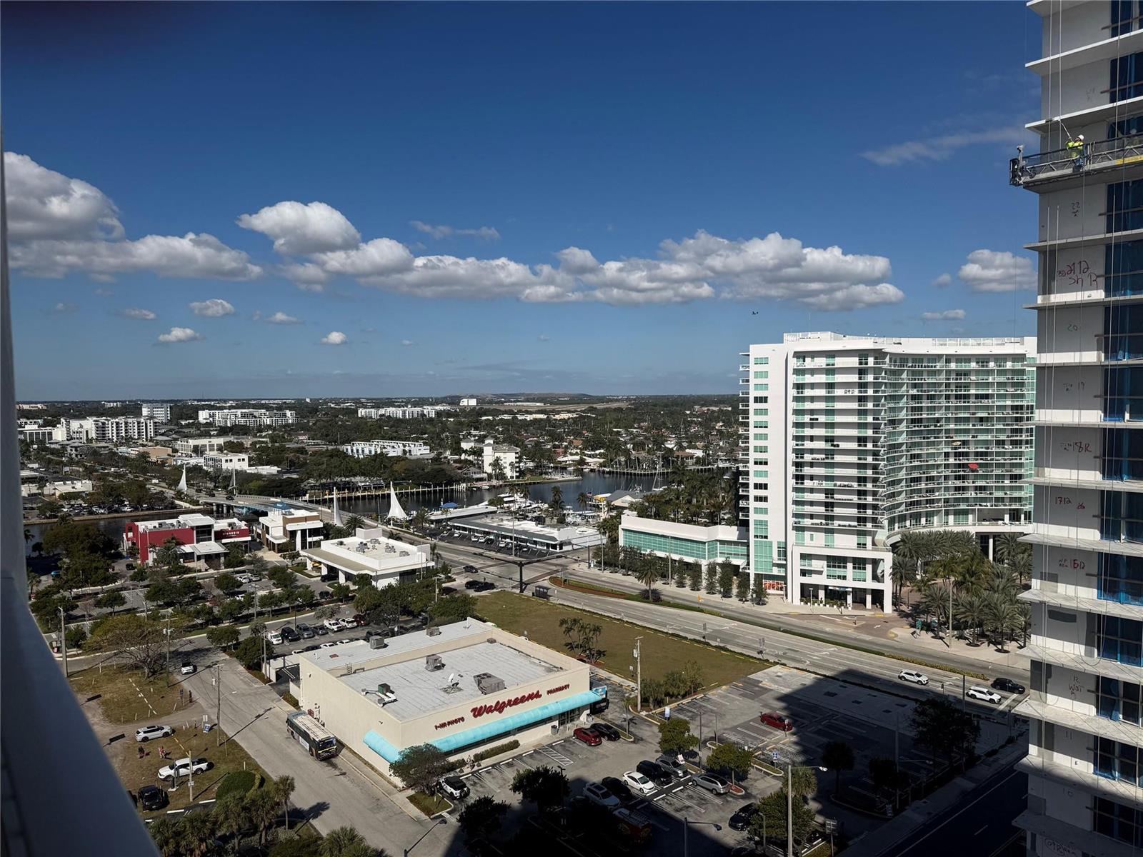 An elevated view shows a city street, a Walgreens store, and a nearby high-rise building — 111 Briny Avenue # 1909, Pompano Beach FL 33062, POMPANO BEACH, FL