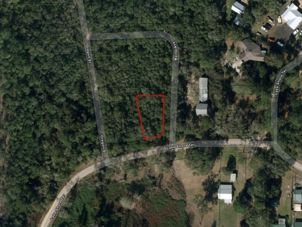 An aerial map view shows a vacant, wooded residential lot outlined in red — 0 Lakeshore Terrace, FL 32148, FL