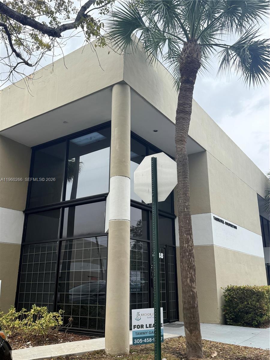 A two-story commercial building features a tan facade, floor-to-ceiling windows, and a palm tree — 4848 SW 74th Ct # 9, Miami FL 33155, MIAMI, FL