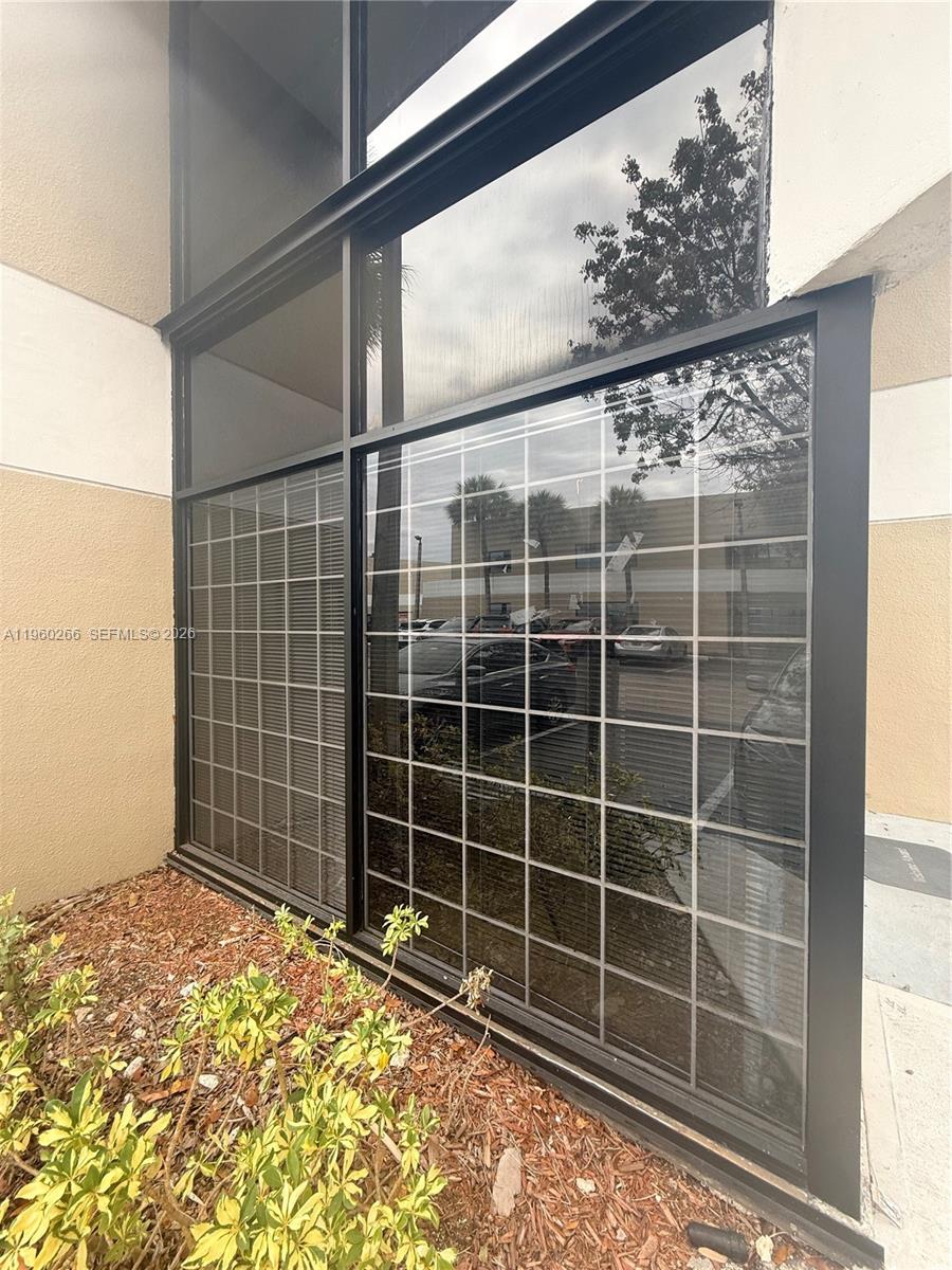 A ground-level exterior view shows a large window with a grid pattern and dark framing — 4848 SW 74th Ct # 9, Miami FL 33155, MIAMI, FL