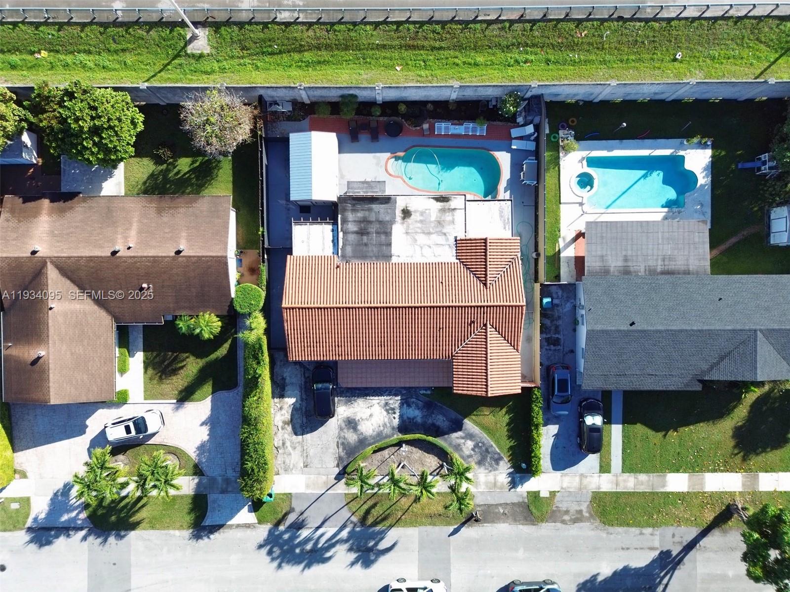 An aerial view shows three suburban houses with pools, driveways, and landscaped yards — 2711 SW 117th Ct, Miami FL 33175, MIAMI, FL