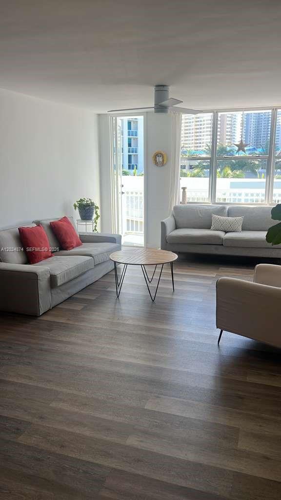 A living room features two gray sofas, a round coffee table, and a balcony door — 1913 S.Ocean dr. # 429, Hallandale Beach FL 33009, HALLANDALE BEACH, FL