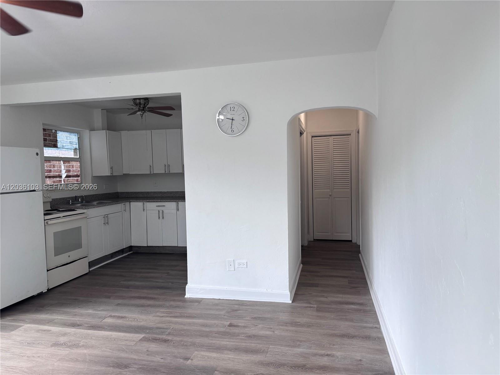 A kitchen with white cabinets and a hallway with a louvered door are visible — 1238 NE 110th St # 1, Miami FL 33161, MIAMI, FL