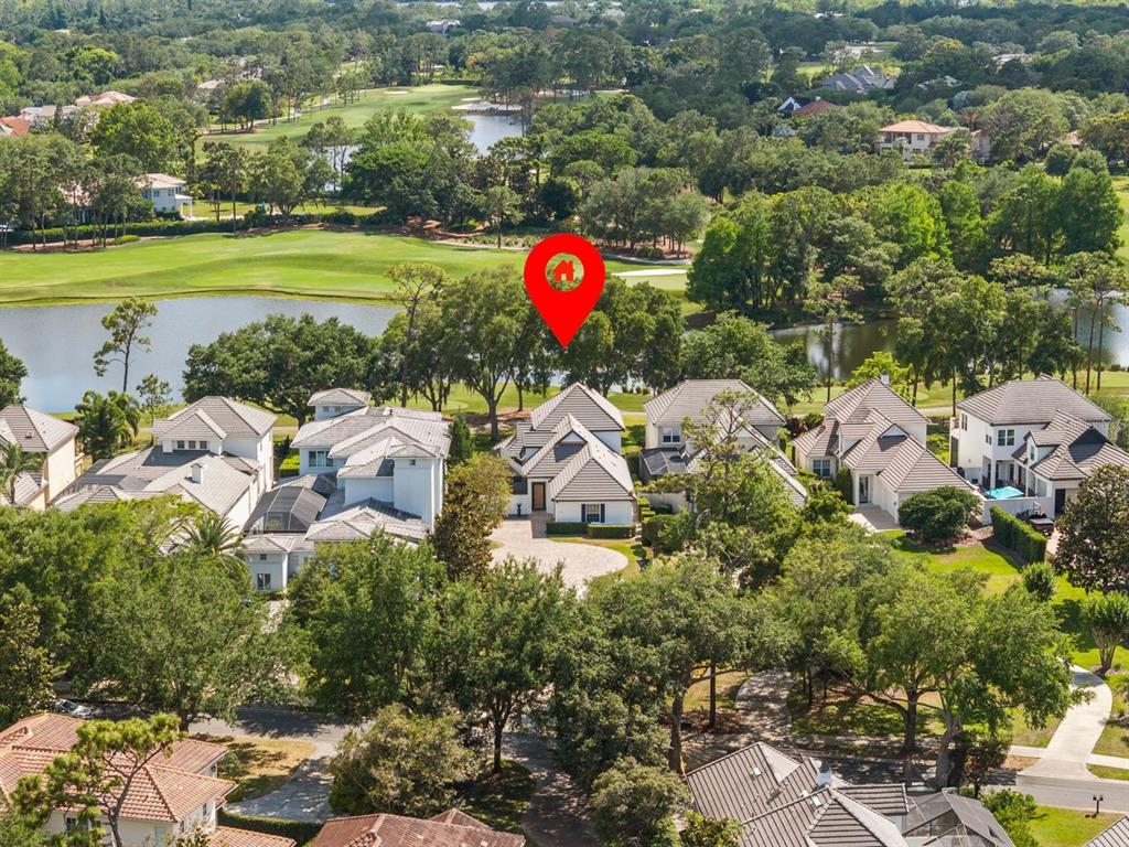 An aerial view shows a house with a red location pin near a golf course — 9744 COVENT GARDEN DRIVE, ORLANDO, FL