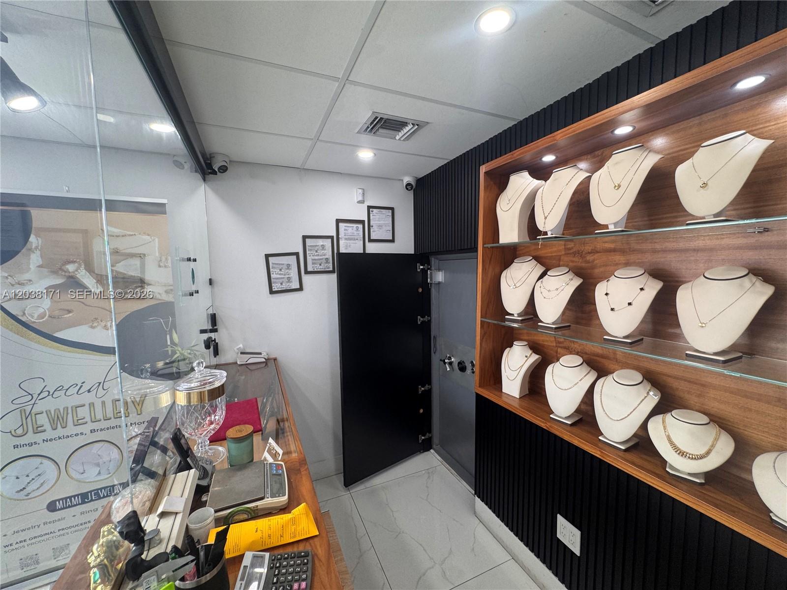 A jewelry store interior features display shelves with necklaces on mannequins and a secure vault door — 108 SW 27th ave, Miami FL 33135, MIAMI, FL