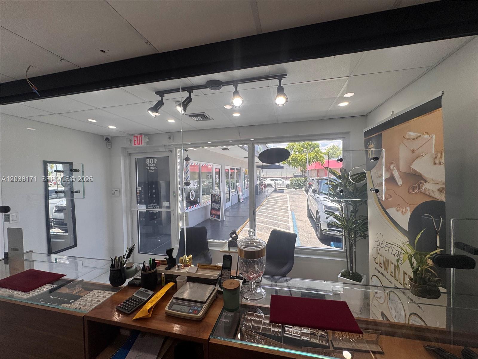 A jewelry store interior features a glass display counter, office equipment, and a view outside — 108 SW 27th ave, Miami FL 33135, MIAMI, FL