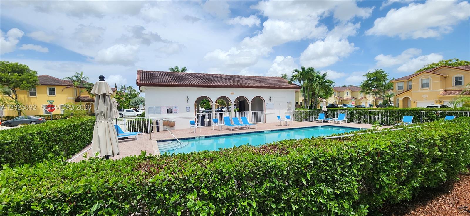 A two-story yellow stucco house features a covered entryway and an attached garage — 8652 NW 112th Ct, Doral FL 33178, DORAL, FL
