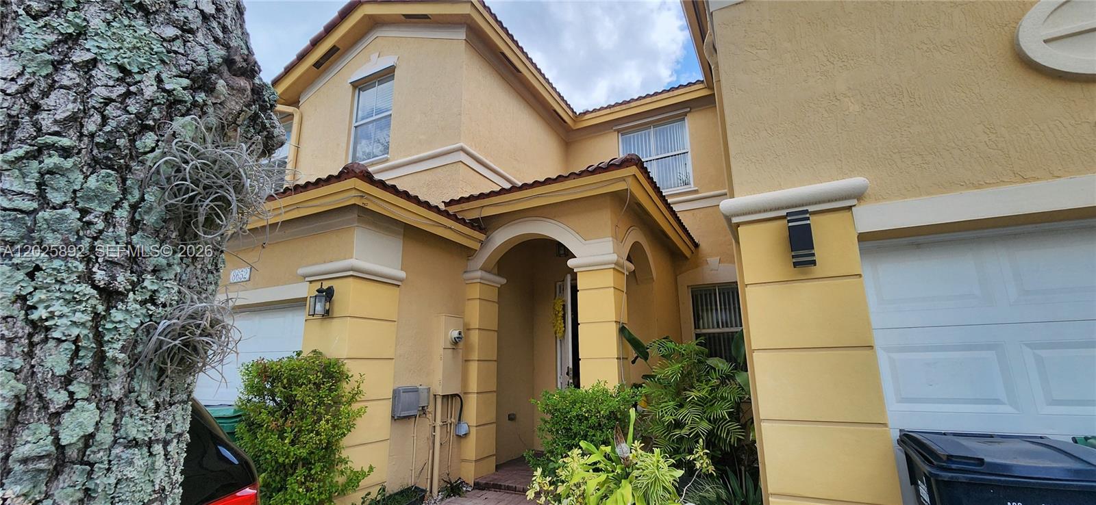 A living room with a staircase leads to a dining area with tile flooring — 8652 NW 112th Ct, Doral FL 33178, DORAL, FL