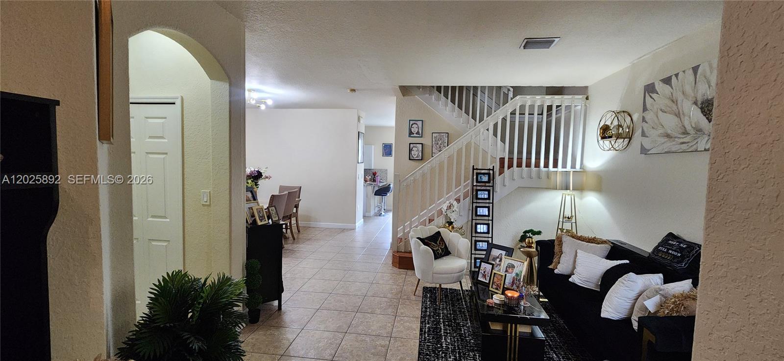A dining room features a wooden table, upholstered chairs, and a bar cart — 8652 NW 112th Ct, Doral FL 33178, DORAL, FL