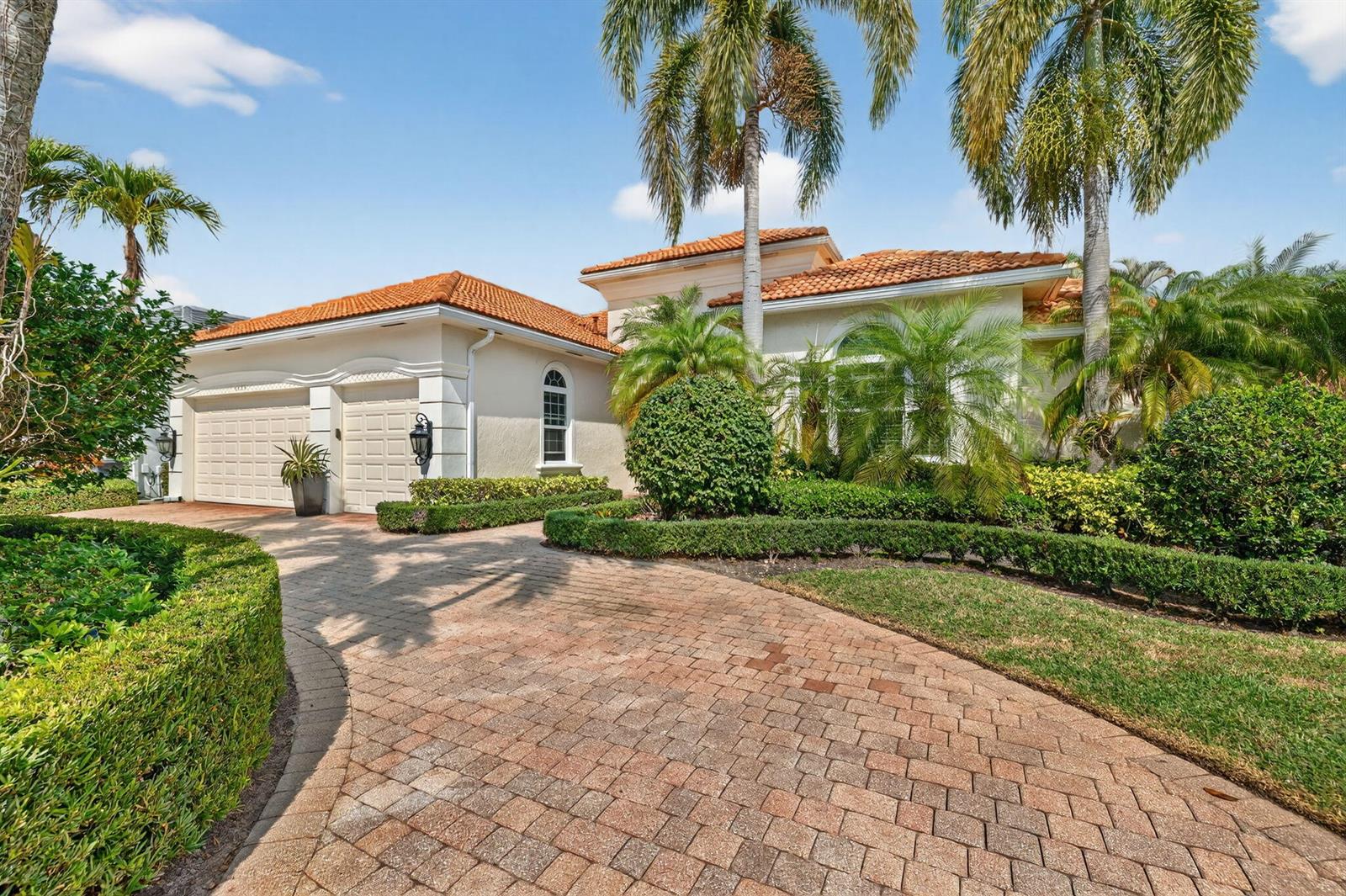 A paved driveway leads to a single-story house with a tiled roof and palm trees — 6629 Grande Orchid Way, Delray Beach FL 33446, DELRAY BEACH, FL