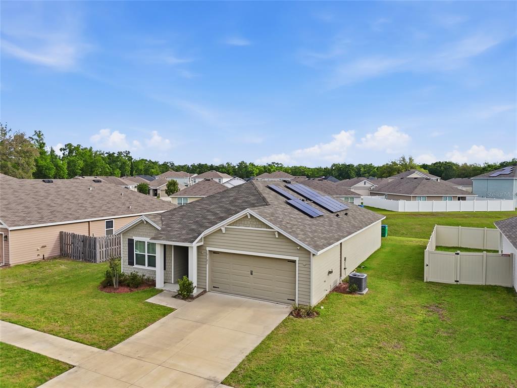 An aerial view of a single-story suburban house with a garage and solar panels — 19142 NW 164TH ROAD, HIGH SPRINGS, FL