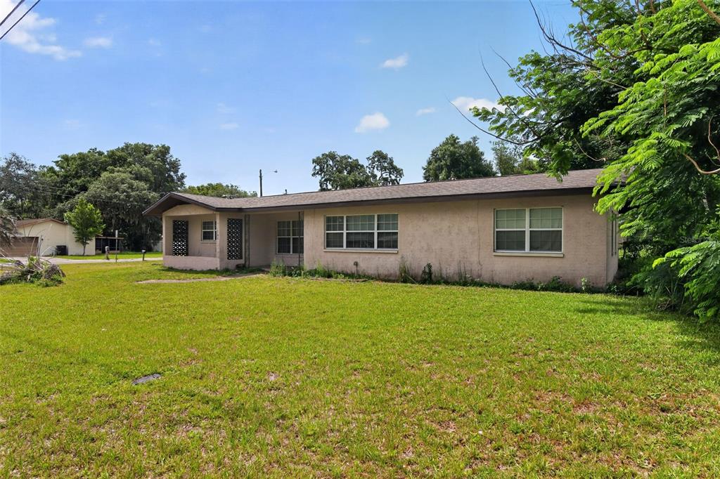 A single-story house with a beige stucco exterior and a covered front porch — 1705 EDEN DRIVE, INVERNESS, FL