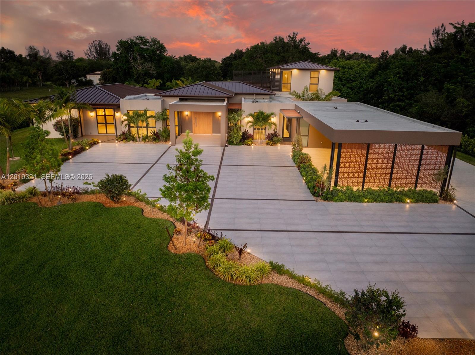 An aerial view of a modern house with a large paved driveway and landscaped lawn — 5500 SW 148th Ave, Southwest Ranches FL 33330, SOUTHWEST RANCHES, FL