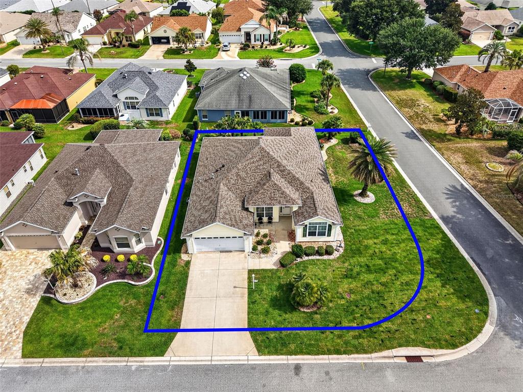 An aerial view shows a single-story house with a large corner lot and driveway — 2234 WESTCHESTER WAY, THE VILLAGES, FL