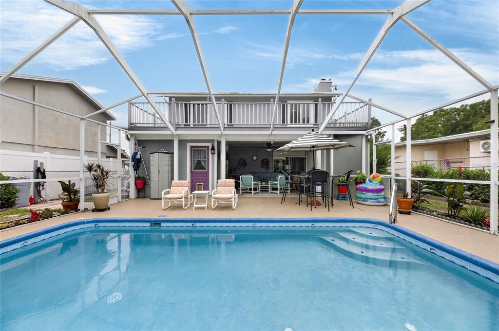 A backyard swimming pool with a screened-in patio and a two-story house exterior — 3312 N LAKE DRIVE, PLANT CITY, FL