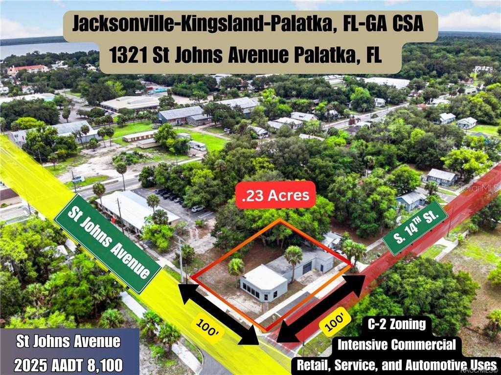 This aerial view shows a commercial property lot with a small building at a corner — 1321 SAINT JOHNS AVENUE, PALATKA, FL