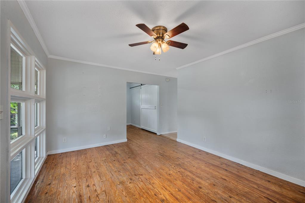 A living room features a sofa, two armchairs, a wooden coffee table, and hardwood floors — 714 W BELMAR STREET, LAKELAND, FL