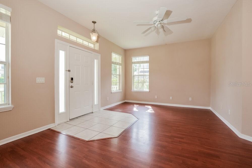 An entryway with wood-look flooring, a tiled landing, white trim, and a ceiling fan — 1814 MADISON IVY CIRCLE, APOPKA, FL