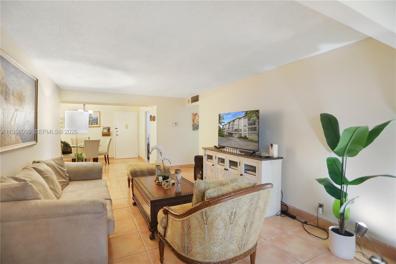 A multi-story apartment building exterior features a central entrance with a covered walkway — 6600 Cypress Rd # 105, Plantation FL 33317, PLANTATION, FL