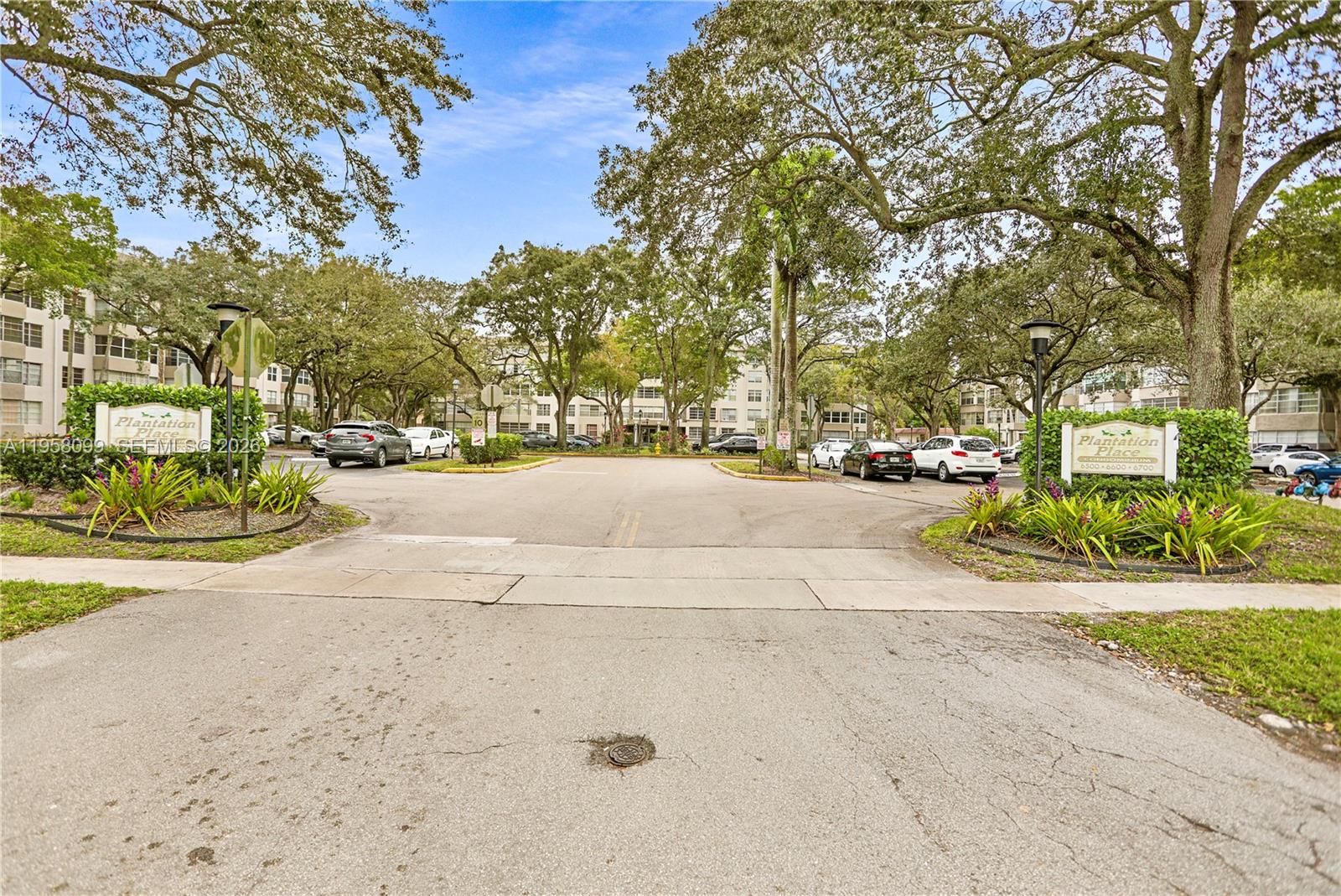 A living room features tile flooring, a beige sofa, a coffee table, and a television — 6600 Cypress Rd # 105, Plantation FL 33317, PLANTATION, FL