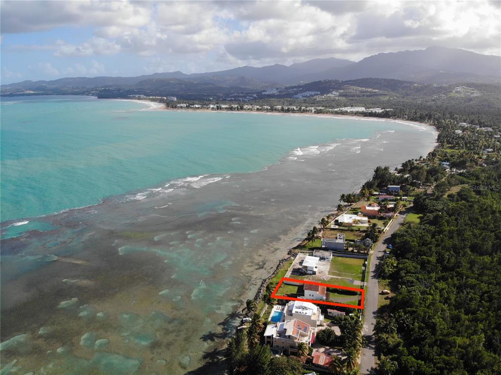 An aerial view shows a coastal property highlighted by a red rectangle near the ocean — 968 CAMINO LAS PICUAS UNIT 14, RIO GRANDE, PR