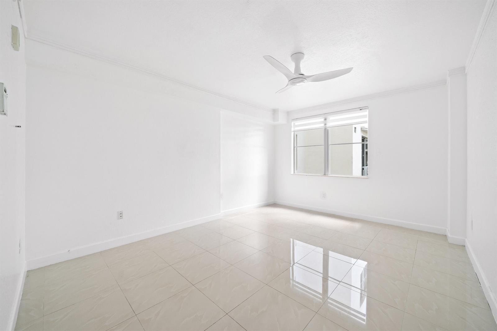 An empty room with white walls, a ceiling fan, and light-colored tiled flooring — 1830 Radius Drive # 405, Hollywood FL 33020, HOLLYWOOD, FL