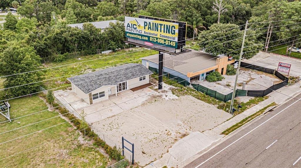 An aerial view shows two commercial buildings on a lot with a large billboard — 4623 LAND O LAKES BOULEVARD, LAND O LAKES, FL