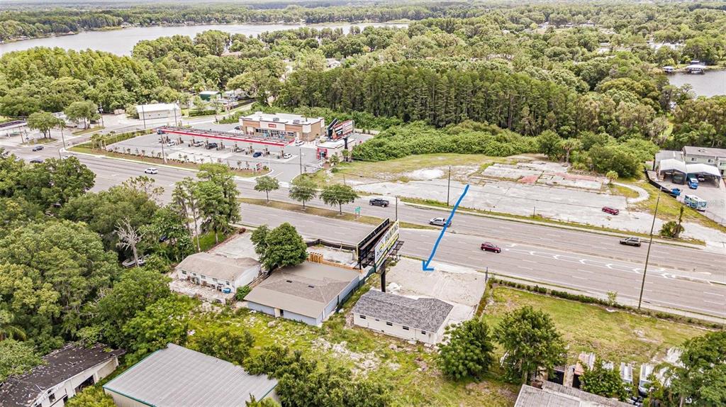 An aerial view shows a commercial property with a billboard and a vacant lot — 4623 LAND O LAKES BOULEVARD, LAND O LAKES, FL