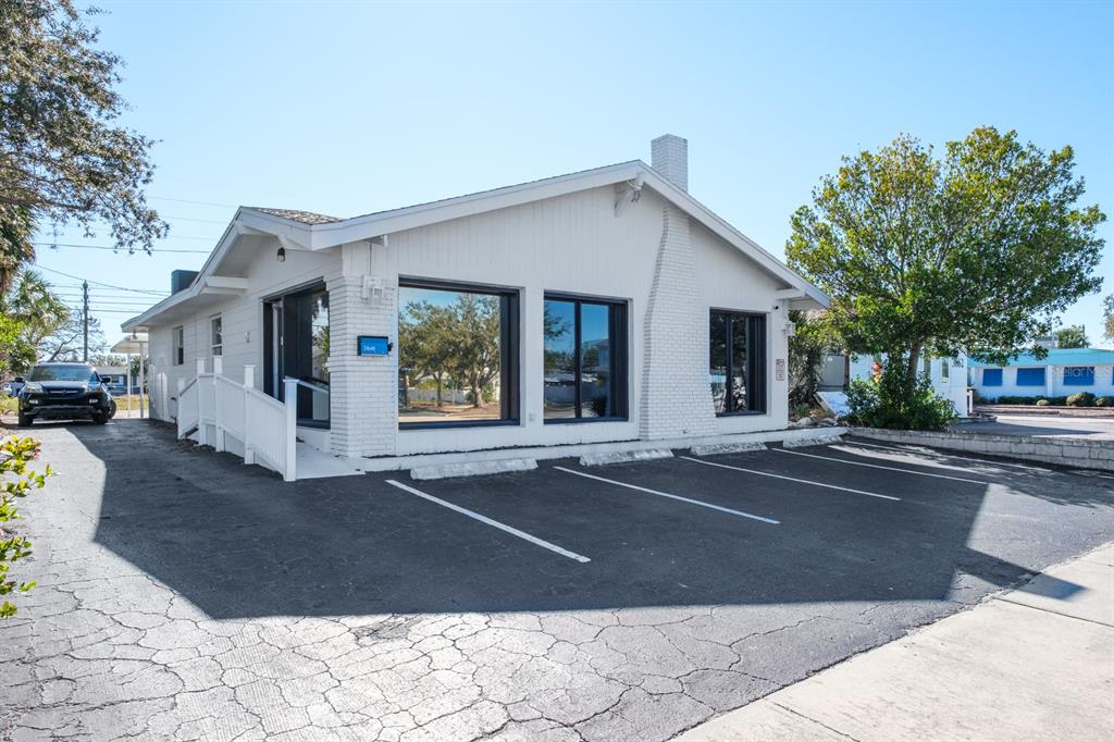 A white, single-story commercial building features a paved parking lot and a wheelchair access ramp — 3848 CENTRAL AVENUE, ST PETERSBURG, FL