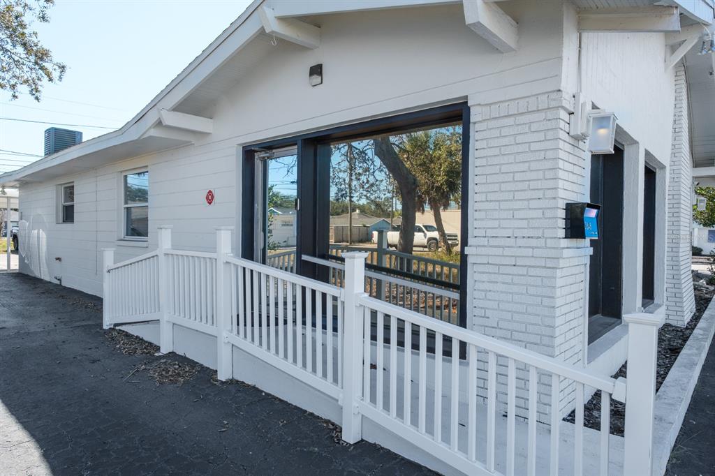 A white brick building exterior features a wheelchair ramp and large glass windows — 3848 CENTRAL AVENUE, ST PETERSBURG, FL