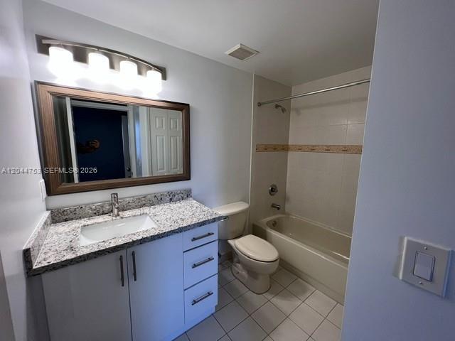 A bathroom features a granite-topped vanity, a framed mirror, and a shower-tub combination — 6360 NW 114th Ave # 233, Doral FL 33178, DORAL, FL