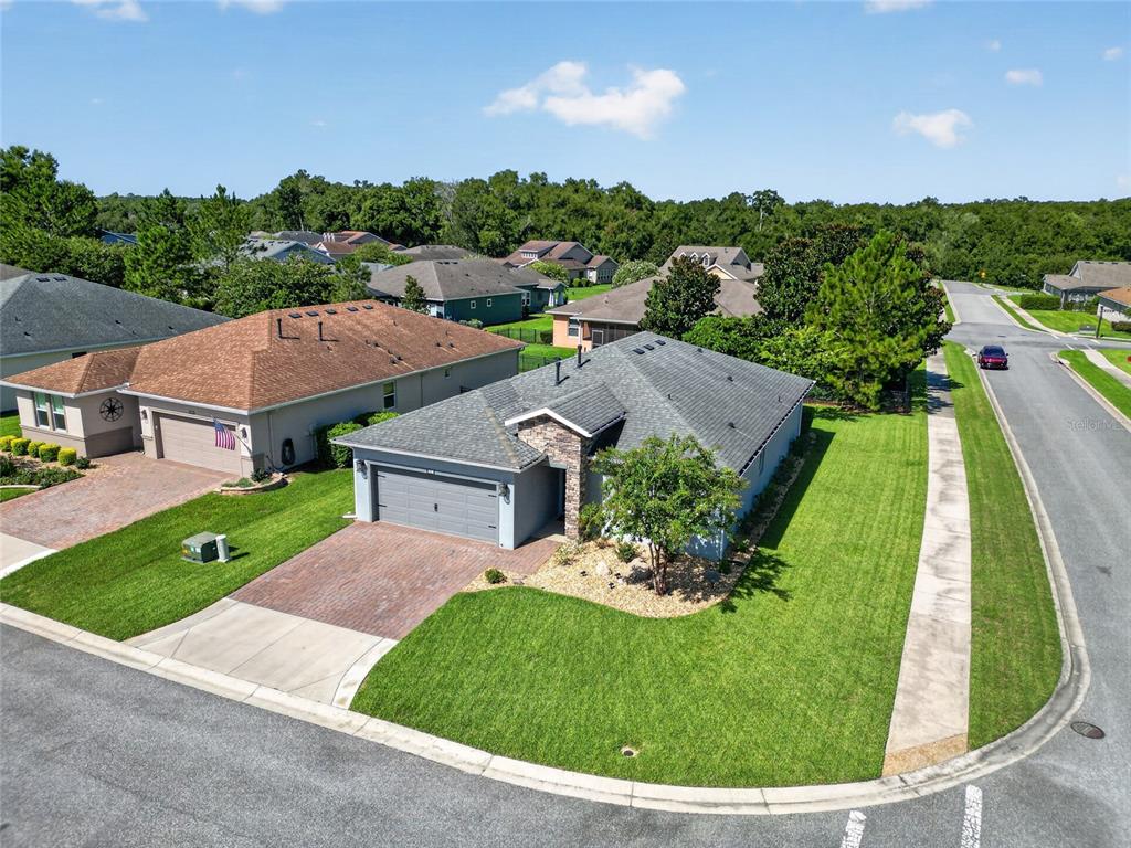 An aerial view shows a single-story suburban house with a gray roof and brick driveway — 3508 NW 55TH COURT, OCALA, FL