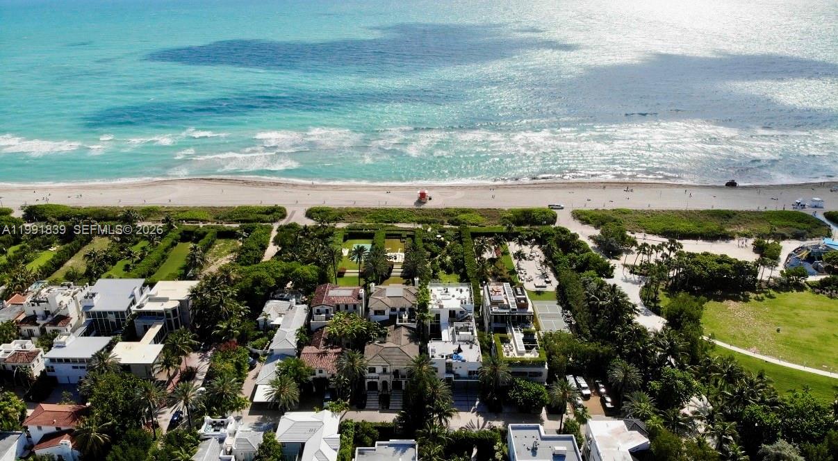 An aerial view shows luxury beachfront homes with private pools and tennis courts near the ocean — 7728 Collins Ave # 16, Miami Beach FL 33141, MIAMI BEACH, FL