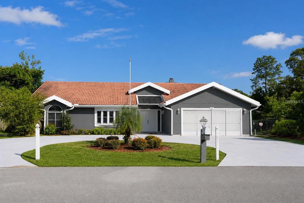 A single-story house with a gray exterior, a red tile roof, and a two-car garage — 10 FALLS PLACE, PALM COAST, FL