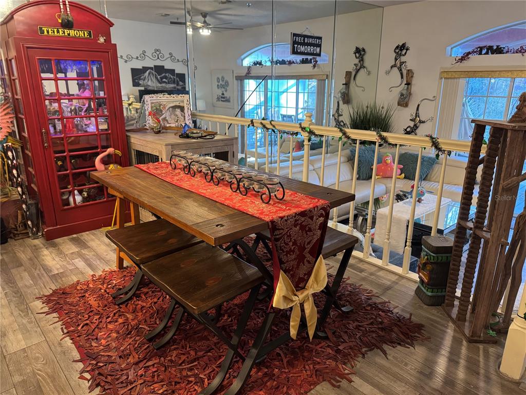 A dining area features a wooden table, benches, a red runner, and a red telephone booth — 2111 VISTA DEL SOL CIRCLE UNIT 403, LUTZ, FL