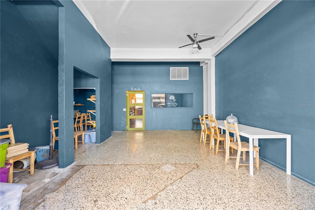 A room with blue walls, a terrazzo floor, a ceiling fan, and a long table — 311 MENDEZ VIGO, DORADO, PR