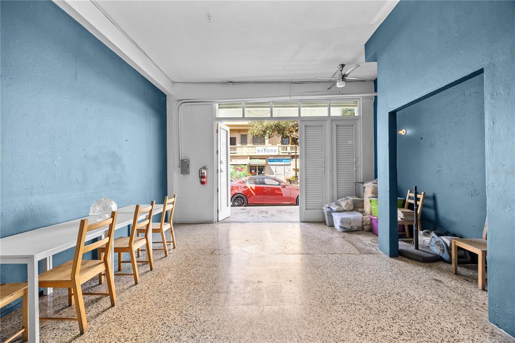 An empty room with blue walls, a long white table, chairs, and a glass doorway — 311 MENDEZ VIGO, DORADO, PR