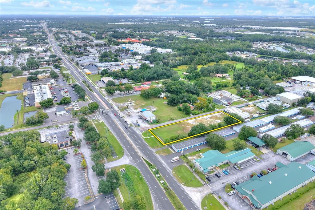 An aerial view shows a vacant rectangular lot outlined in yellow next to a road — E RAYBURN ROAD, PLANT CITY, FL