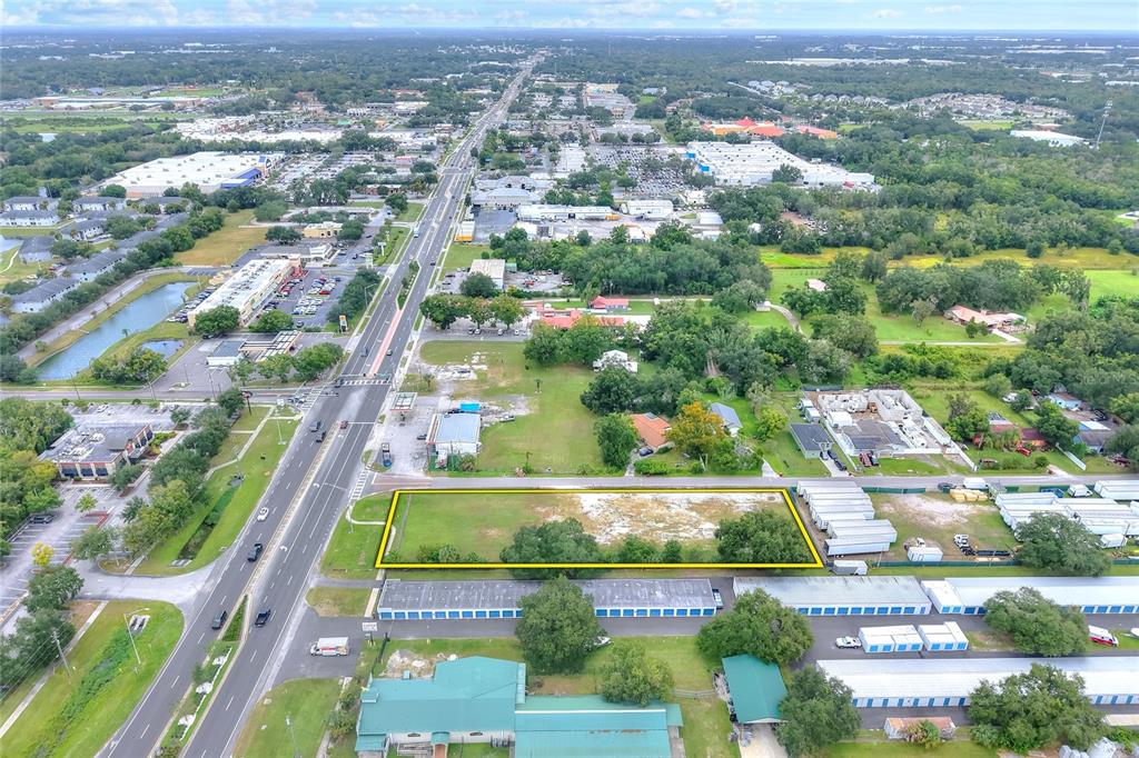 An aerial view shows a rectangular vacant lot outlined in yellow next to a road — E RAYBURN ROAD, PLANT CITY, FL