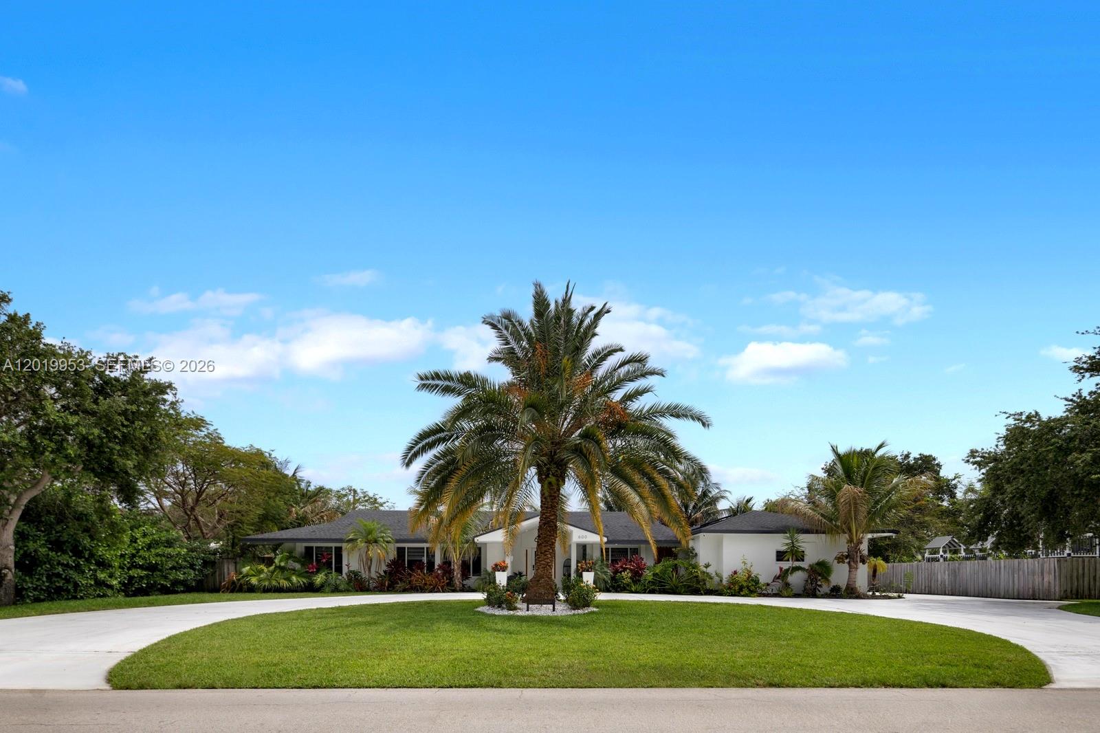 A single-story white house features a circular driveway and a prominent palm tree — 600 NE 4th St, Pompano Beach FL 33060, POMPANO BEACH, FL