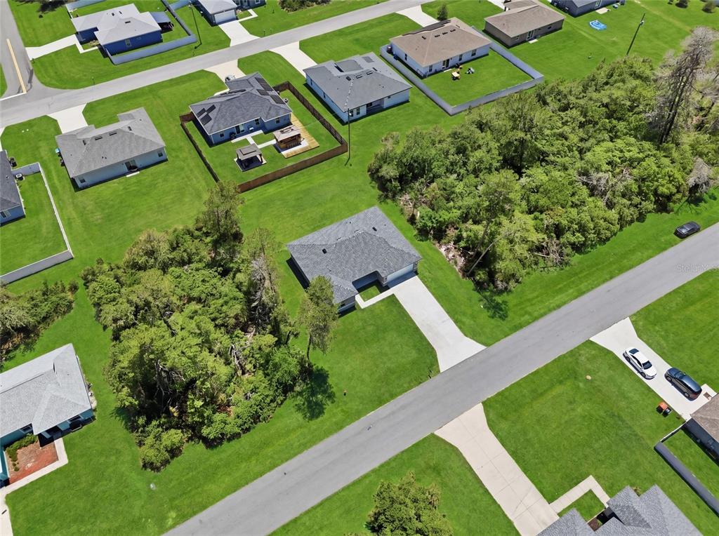 An aerial view shows a suburban neighborhood with several single-family homes and wooded areas — 2780 SW 162ND LANE, OCALA, FL