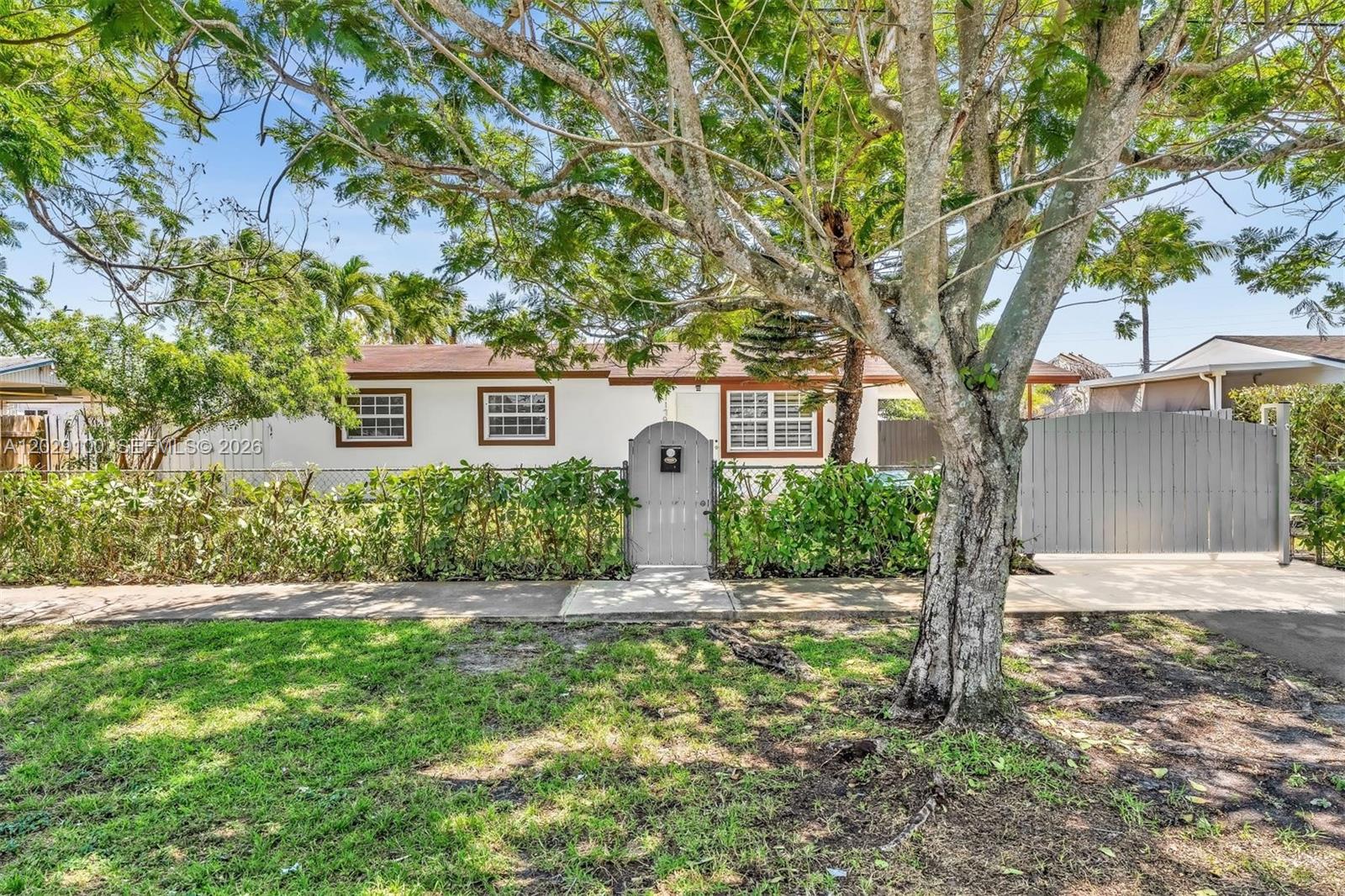 A single-story house with a white exterior, brown trim, and a gray gated entrance — 11790 SW 34th St, Miami FL 33175, MIAMI, FL