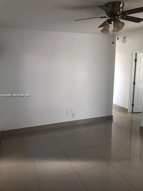 A room with white walls, light-colored tile flooring, and a ceiling fan with lights — 1045 SW 4th St # 5, Miami FL 33130, MIAMI, FL