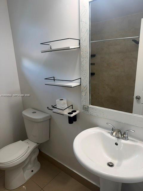 A bathroom features a pedestal sink, a toilet, and two wall-mounted shelves — 1045 SW 4th St # 5, Miami FL 33130, MIAMI, FL